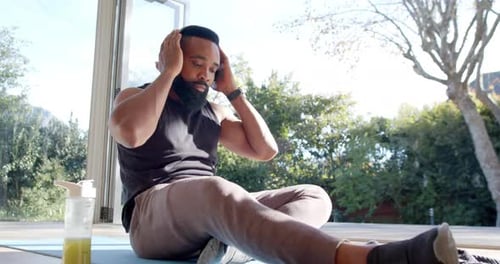 Man Putting on Headphones for a Home Workout