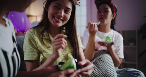 Friends Celebrating a Birthday at Home Eating Cake