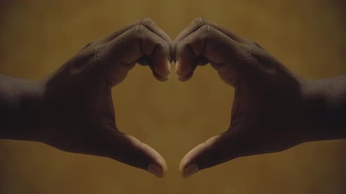 hape of heart with hands love sign