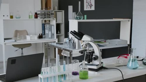 Modern Microscope and Laboratory Equipment on Bench