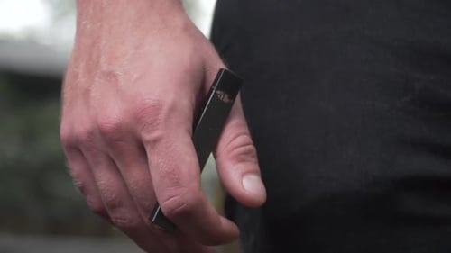 Close Up of Hand Holding Vaporizer