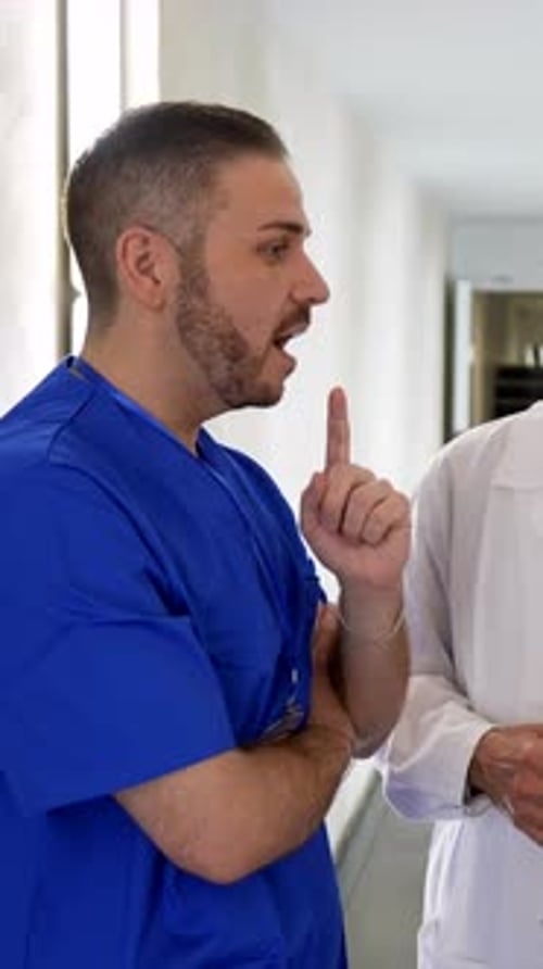 Medical team discussing patient diagnosis in hospital corridor