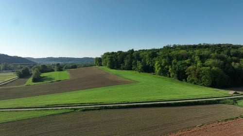 Aerial view of green fields and forest, France.