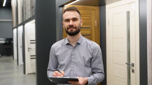 Seller with Clipboard in Doors Store