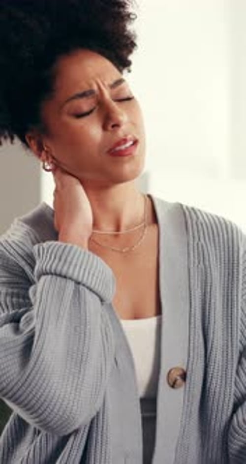 Young Woman Massaging Stiff Neck Muscles For Relief