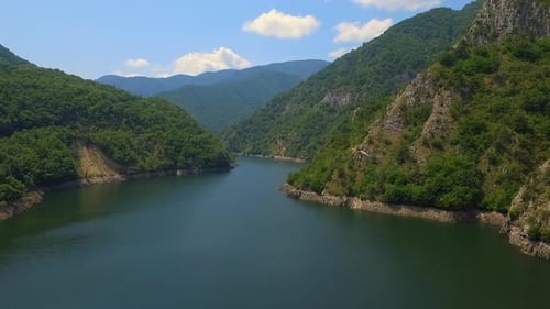 Mountain lake with turquoise water and green trees. Reflection in the water. Beautiful spring landsc