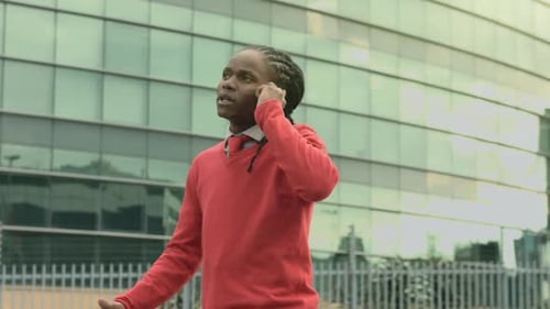 Young Man Talking on Phone in Urban Setting