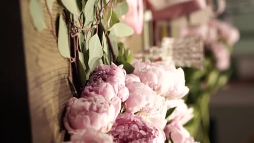 Florist Crafting Bouquet. Florist at Work. Florist makes bouquet in flower shop in Lviv Vertical