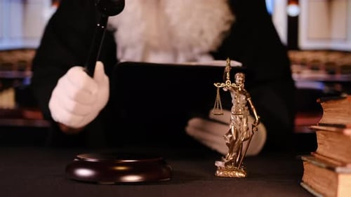 A Detailed Courtroom Scene Featuring a Prominent Gavel Alongside Lady Justice