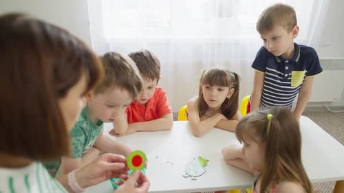 Young Children Learning with Teacher in Classroom