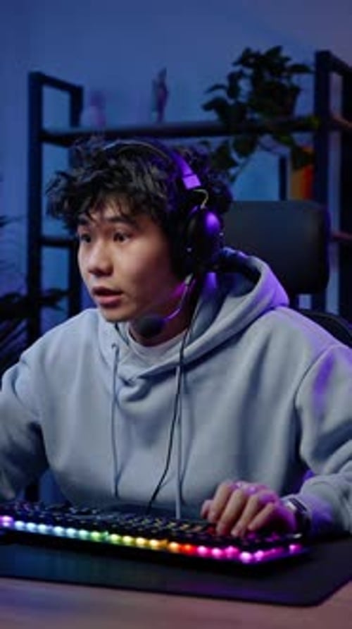 Excited Young Man Playing Video Game at Night