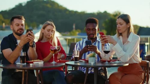 Company Friends Sitting at Street Cafe Eating Drinking Use Smartphones Cityscape Smiling Phone