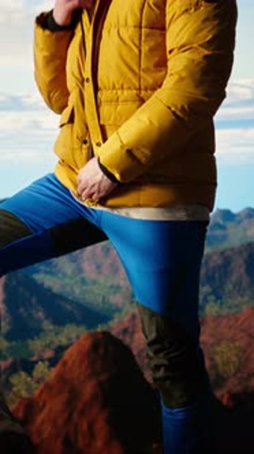 Vertical Video Determined Climber Gazes at the Sky and Rocky Mountain Tops