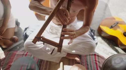 Hands of Spiritual Coach Sitting in Lotus Position Playing the Tibetan Flute in Sound Healing