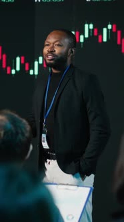 Vertical Video African American Stockbroker Explains Trading Performance and Profit Trends