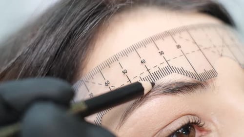 Woman Getting Eyebrows Shaped Close Up