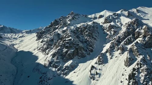 Rocky icy environment, tranquil remote mountain landmark, aerial view