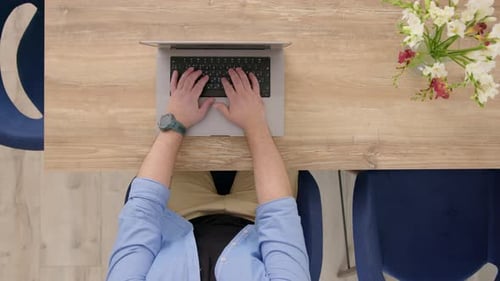 Top Down View Unrecognizable Man in Blue Shirt is Typing on Computer Businessman Working From Home