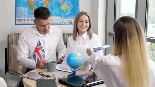 Travel Agents Giving Passports to a Couple