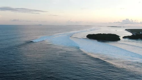 green island with white sand beach waves and blue lagoon surfing spot cokes