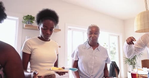 Friends Gather in Kitchen for Food and Drinks