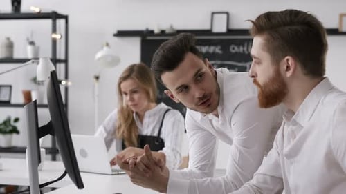 Trendy caucasian hipster man in bright startup office shares project idea