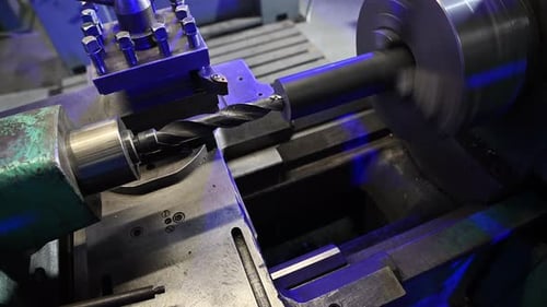 Lathe Machine Operator Processing Piece of Metal Element