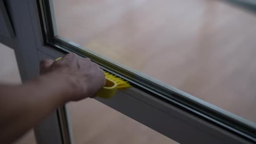 Hand Cleaning Window Frame with Brush