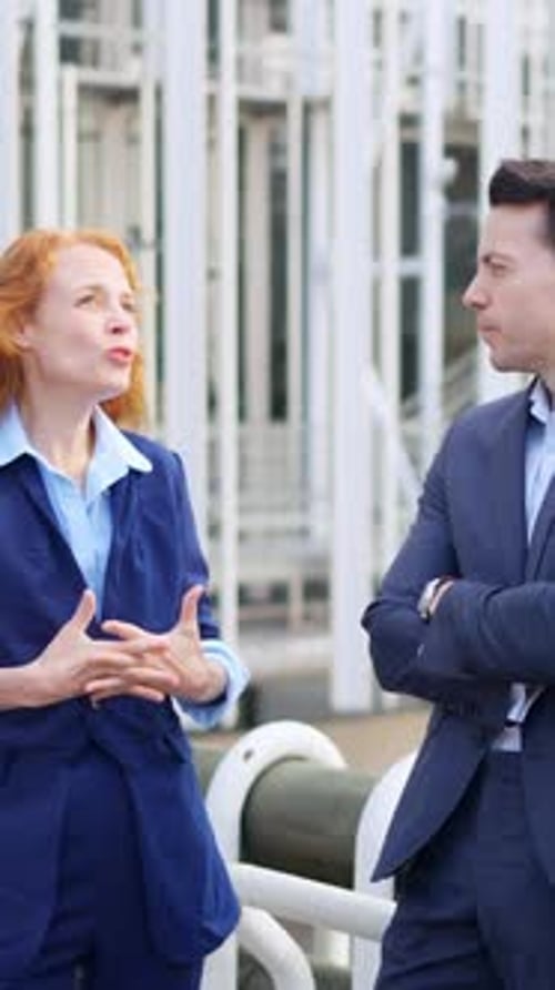 Professionals Discuss Business in City Environment