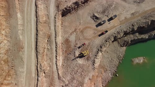 Aerial View of Industrial Opencast Mining Quarry with Lots of Machinery at Work Extracting Fluxes