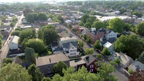 Cinematic aerial dolly shot of historic district in restored Old Town Lititz Pennsylvania, people li