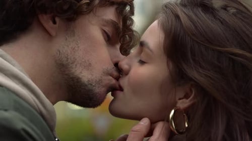 Affectionate young couple kissing tenderly on urban street in slow motion New York City