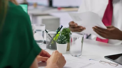 Job Candidate Hands Over His CV to Team of HR Professionals to Start Interview