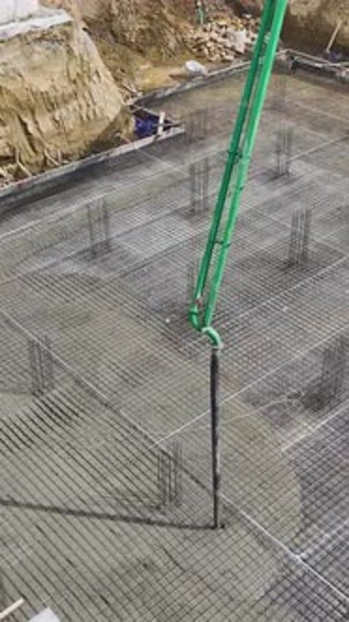 Vertikale Videotechniker beaufsichtigen die Arbeiter beim Formen von Bewehrungsstahl und beim Gießen von Beton in hoher Qualität