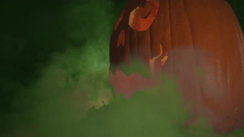 Illuminated Carved Pumpkin Surrounded By Eerie Green Fog