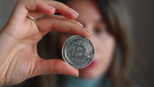 Woman holding a bitcoin crypto currency close up