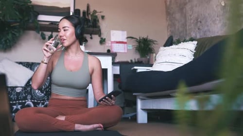 Woman Drinks Water After Workout at Home