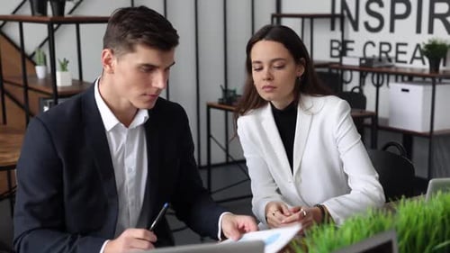 Professionals Discussing Strategy in Bright Modern Workplace
