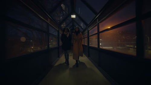 Lifestyle Portrait of Two Young Women Watching Tower Building Together