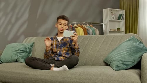 Teen Talking on Smart Phone at Home