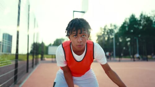 Teen Basketball Player Dribbling Outdoors on Urban Court