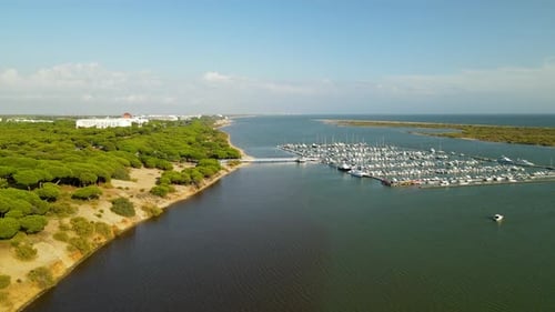 Aerial fly over Dock with many Yachts, Sailboats, Ships at Piedras river Puerto Marina El Rompido, S