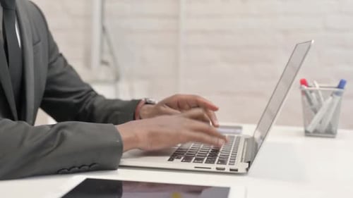 Close up of African Businessman Working on Laptop