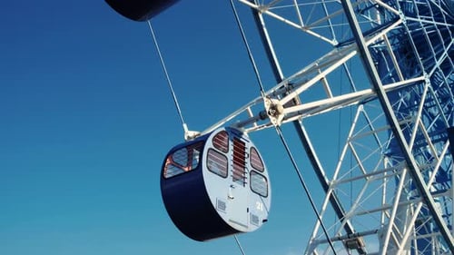 Ferris Wheel Rotating Under Blue Sky