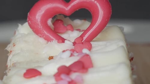 Romantic close-up of heart-shaped topper on red velvet brownie for Valentine’s Day