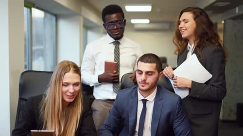 Diverse Office Corporate Workers Discuss Project on Laptop Display in Office Multiethnic People