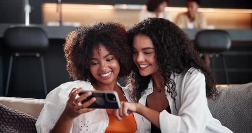 Laughing, phone and selfie with friends on sofa in coffee shop for memories