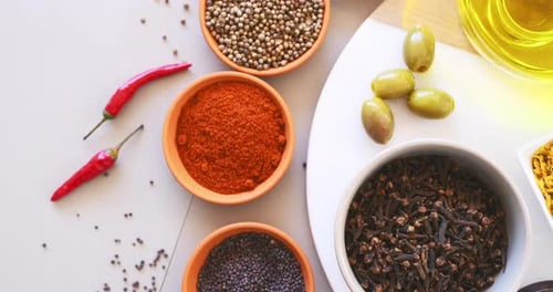 Spices, herbs and powder with top view on table in kitchen for cooking, food