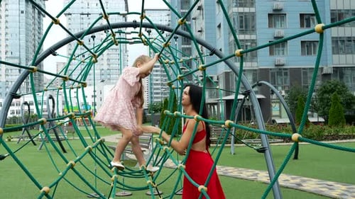 Playful Moments at the Park Between a Mother and Daughter on a Sunny Day
