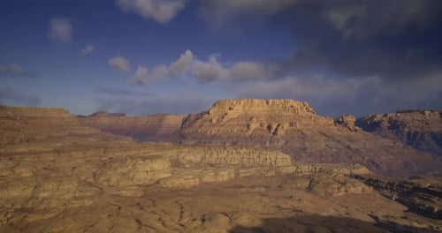 Stunning Landscape View of a Desert Plateau Under Cloudy Skies at Dusk